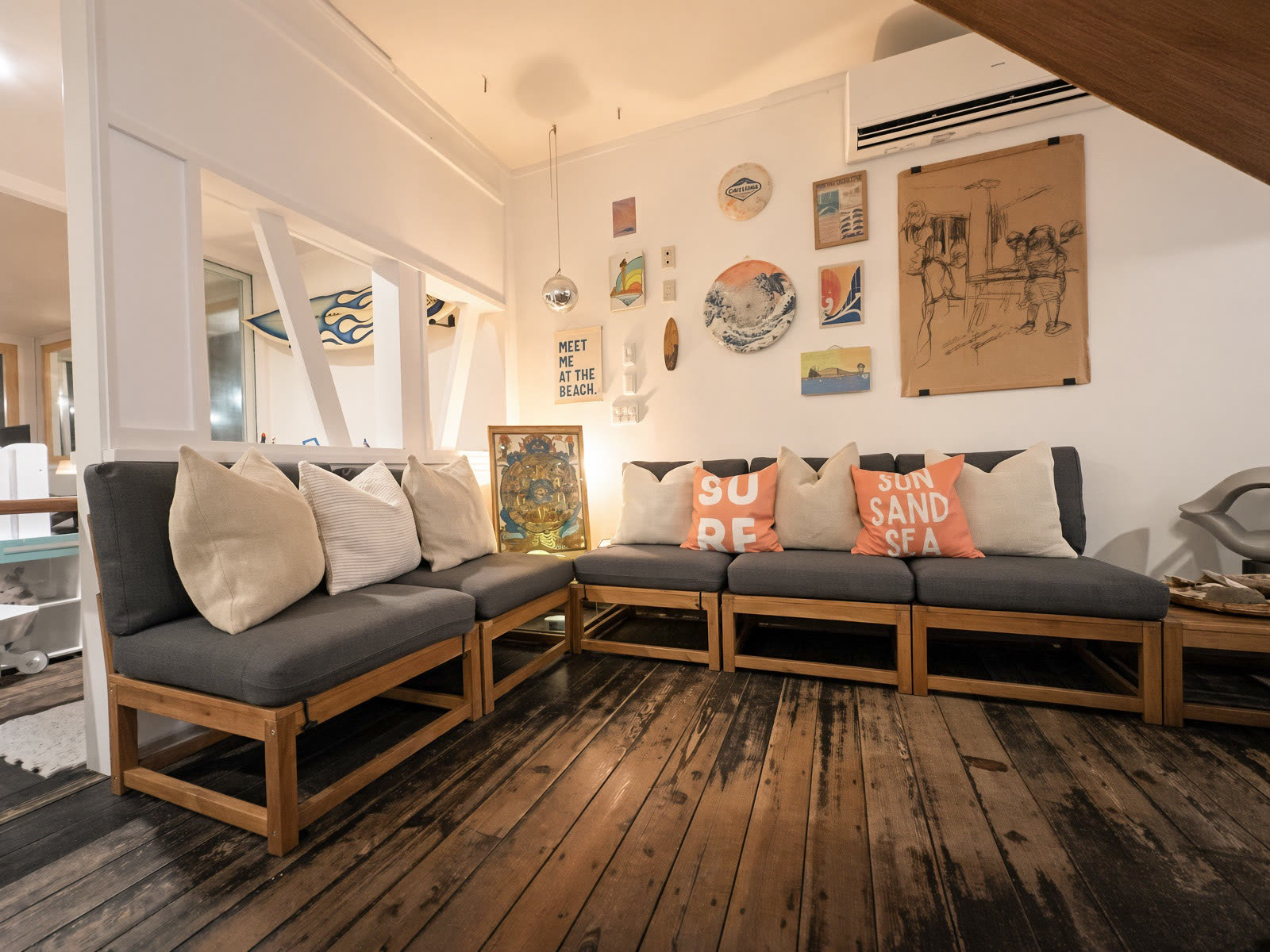 The lounge, surf art and old wood floors